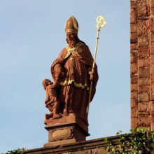 Heiligenfigur vor der Kirche. Sankt Martin gibt einem Bettler Almosen.